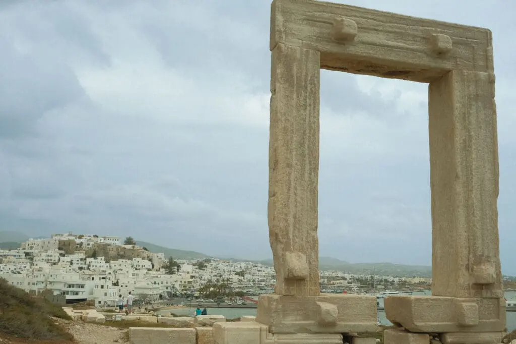 traveling to greece tips portara temple of apollo on naxos with white village in the background