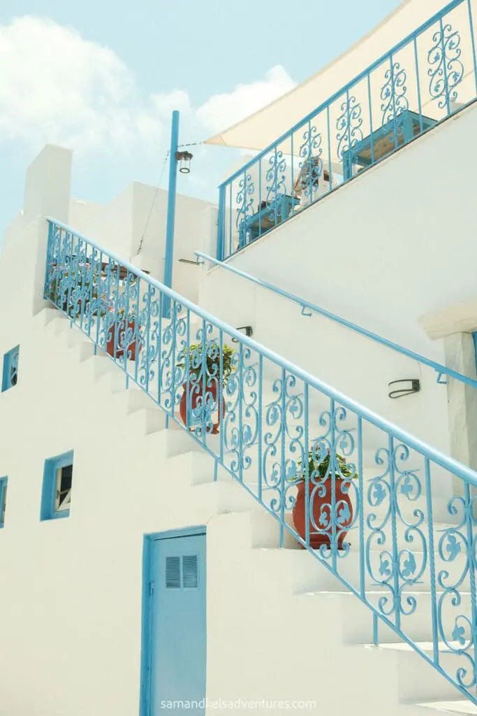 greece island hopping itinerary lefkes white building and blue railings and doors