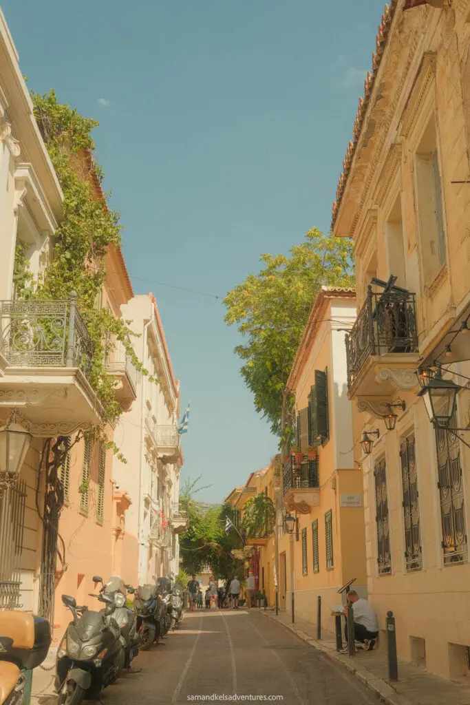 traveling to greece tips street with leaves and motorbikes on the side